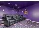 Home theater with purple walls, reclining seats, and projector at 3503 E Princeton Ct, Gilbert, AZ 85234