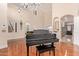 Grand two-story living room with a piano and hardwood floors at 3503 E Princeton Ct, Gilbert, AZ 85234