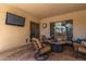 Covered patio with seating area and TV at 3503 E Princeton Ct, Gilbert, AZ 85234