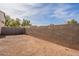 Empty lot with block wall and gravel. Sunny day at 402 N 66Th Ln, Phoenix, AZ 85043