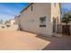 Tan house exterior with backyard view. Shows sliding glass door access at 402 N 66Th Ln, Phoenix, AZ 85043