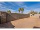 Backyard with gravel, block wall, and satellite dish at 402 N 66Th Ln, Phoenix, AZ 85043