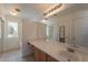 Bathroom features a vanity, sink, shower, and bathtub at 402 N 66Th Ln, Phoenix, AZ 85043