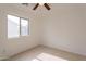 Simple bedroom with a window and tile flooring at 402 N 66Th Ln, Phoenix, AZ 85043
