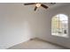 Bright bedroom with ceiling fan and arched window at 402 N 66Th Ln, Phoenix, AZ 85043