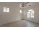 Bright bedroom with arched window and ceiling fan at 402 N 66Th Ln, Phoenix, AZ 85043