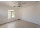 Spacious bedroom with arched window and ceiling fan at 402 N 66Th Ln, Phoenix, AZ 85043