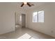 Bright bedroom featuring a mirrored closet and ceiling fan at 402 N 66Th Ln, Phoenix, AZ 85043