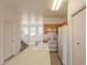 Kitchen with white appliances and wood cabinets at 402 N 66Th Ln, Phoenix, AZ 85043