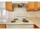 White electric cooktop and range hood at 402 N 66Th Ln, Phoenix, AZ 85043
