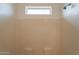 Shower stall with tiled walls and a window above at 402 N 66Th Ln, Phoenix, AZ 85043