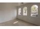 Spare bedroom with three windows and tiled floors at 402 N 66Th Ln, Phoenix, AZ 85043