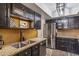 Updated kitchen with dark cabinetry, granite counters, and stainless steel appliances at 4141 N 31St St # 215, Phoenix, AZ 85016