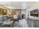 Spacious living room featuring comfortable seating, a large TV, and patio access at 4141 N 31St St # 215, Phoenix, AZ 85016