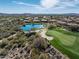 Aerial view showing a community near a golf course and lake at 41717 N Moss Springs Ct, Anthem, AZ 85086