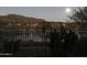 Night view of a backyard with a lake and mountains at 41717 N Moss Springs Ct, Anthem, AZ 85086
