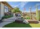 Relaxing backyard patio with seating area, landscaping, and a built-in brick planter at 41717 N Moss Springs Ct, Anthem, AZ 85086