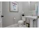 Powder room with pedestal sink and toilet at 41717 N Moss Springs Ct, Anthem, AZ 85086