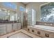 Spa-like bathroom featuring a soaking tub and glass block shower at 41717 N Moss Springs Ct, Anthem, AZ 85086