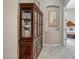 Hallway with a wooden china cabinet and view into a bedroom at 41717 N Moss Springs Ct, Anthem, AZ 85086