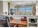 Home office with wood desk, built-in shelving, and views of the backyard at 41717 N Moss Springs Ct, Anthem, AZ 85086