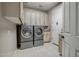 Convenient laundry room with front-load washer and dryer at 41717 N Moss Springs Ct, Anthem, AZ 85086