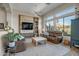 Relaxing living room with leather sofas and a large window overlooking the backyard at 41717 N Moss Springs Ct, Anthem, AZ 85086