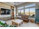 Spacious living room with a stone fireplace, large TV, and comfortable seating at 41717 N Moss Springs Ct, Anthem, AZ 85086