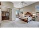 Large main bedroom with a luxurious wooden bed and access to a private patio at 41717 N Moss Springs Ct, Anthem, AZ 85086