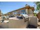 Outdoor kitchen with built-in grill and pizza oven at 41717 N Moss Springs Ct, Anthem, AZ 85086