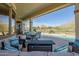 Covered patio with seating area, fire pit, and pool views at 41717 N Moss Springs Ct, Anthem, AZ 85086