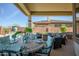 Covered patio with dining and seating area near pool at 41717 N Moss Springs Ct, Anthem, AZ 85086