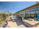 Comfortable patio seating area with a stone table and lush landscaping at 41717 N Moss Springs Ct, Anthem, AZ 85086