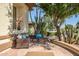 Relaxing patio with wicker furniture and desert plants at 41717 N Moss Springs Ct, Anthem, AZ 85086