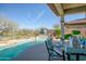 Stunning pool with waterfall feature and dining area at 41717 N Moss Springs Ct, Anthem, AZ 85086