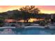 Inviting pool with mountain views at sunset at 41717 N Moss Springs Ct, Anthem, AZ 85086