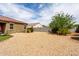 Expansive backyard showcasing desert landscaping and a block fence for privacy at 41917 W Manderas Ln, Maricopa, AZ 85138