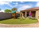 Beautiful backyard oasis with lush artificial turf, a play structure, and a charming seating area at 41917 W Manderas Ln, Maricopa, AZ 85138