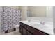Bathroom with double vanity, tile floor, and shower with patterned curtain at 41917 W Manderas Ln, Maricopa, AZ 85138