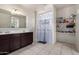 Bathroom featuring a double sink vanity, tile flooring, and a shower with a curtain at 41917 W Manderas Ln, Maricopa, AZ 85138