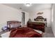 Cozy bedroom with neutral carpeting, a crib, and a comfortable bed at 41917 W Manderas Ln, Maricopa, AZ 85138