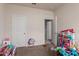 Bedroom with white doors, carpet, and natural light from the window at 41917 W Manderas Ln, Maricopa, AZ 85138