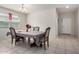 Traditional dining room featuring a large table set for an elegant meal, bathed in soft, natural light at 41917 W Manderas Ln, Maricopa, AZ 85138