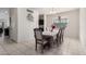 Bright dining room featuring a large window and an elegant dining set at 41917 W Manderas Ln, Maricopa, AZ 85138