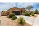 Beautiful single-story home boasting a tidy front yard, a long driveway, and an attached two-car garage at 41917 W Manderas Ln, Maricopa, AZ 85138