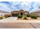 Charming home featuring a well-manicured front yard with low maintenance desert landscaping and a two-car garage at 41917 W Manderas Ln, Maricopa, AZ 85138