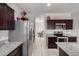 Open-concept kitchen featuring stainless steel appliances and granite countertops at 41917 W Manderas Ln, Maricopa, AZ 85138
