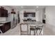 Spacious kitchen with stainless steel appliances, granite countertops, and center island at 41917 W Manderas Ln, Maricopa, AZ 85138