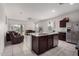 Open kitchen area with granite countertops, stainless steel appliances, and seamless access to the living room at 41917 W Manderas Ln, Maricopa, AZ 85138