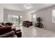 Bright living room with tile floors, neutral walls, and large windows offering plenty of natural light at 41917 W Manderas Ln, Maricopa, AZ 85138